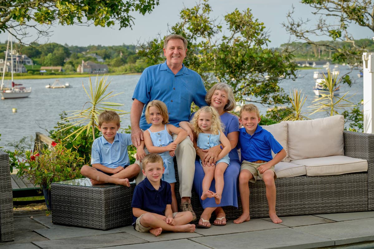 grandparents with their grandkids poolside at their vacation home in Chatham, ma
