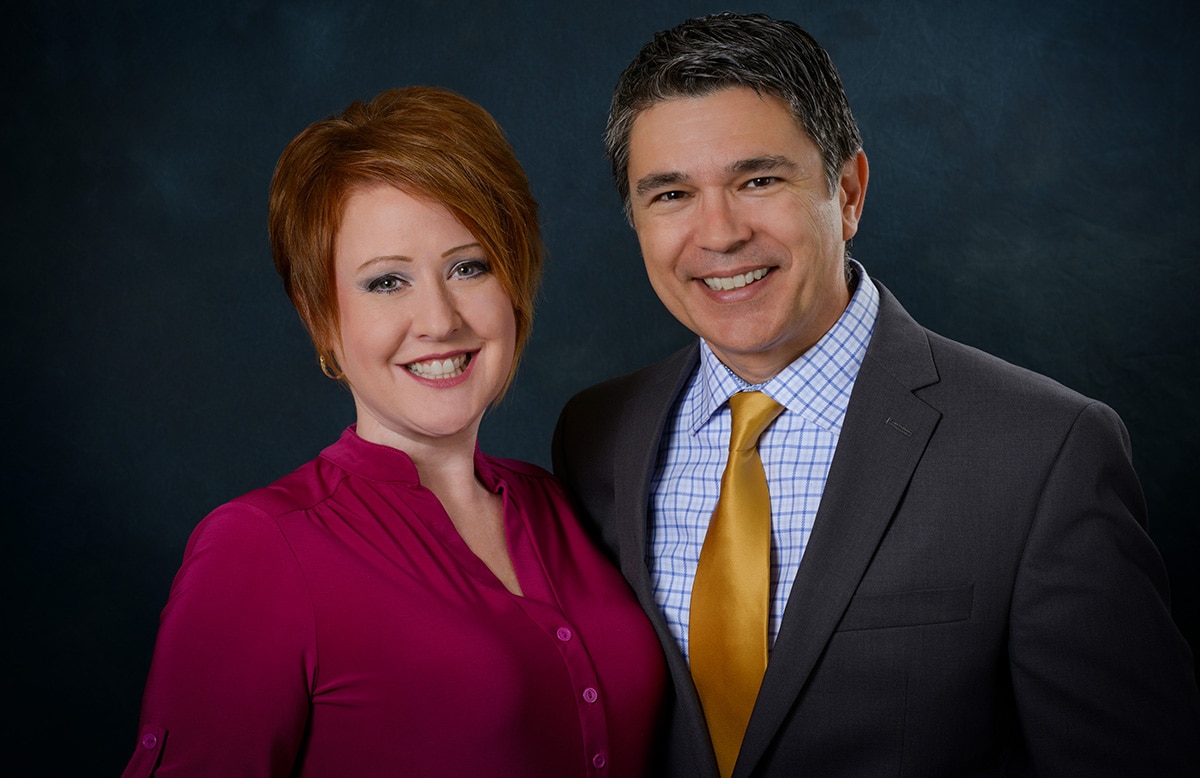 husband and wife business owner posing for a headshot for their website
