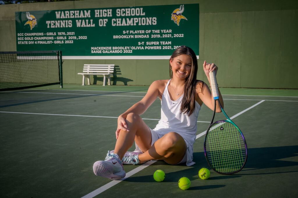 high school senior tennis player posing with her tennis racket on a tennis court in wareham, ma