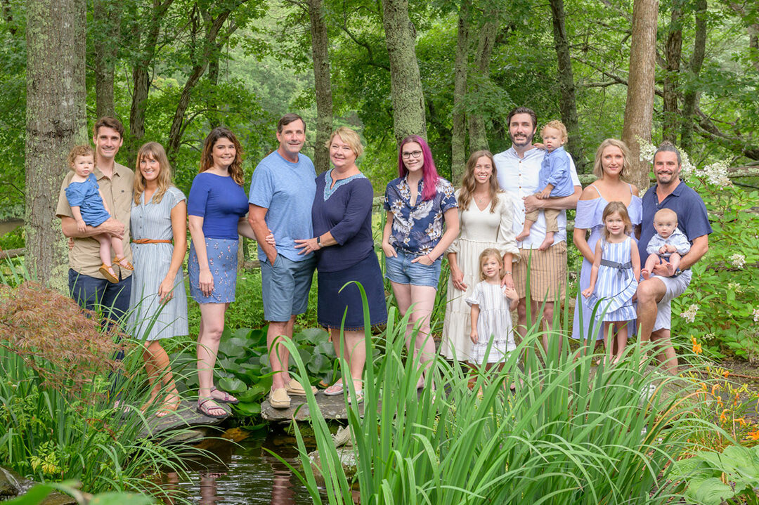 multi generations family posing in the backyard of their summer house in falmouth ma