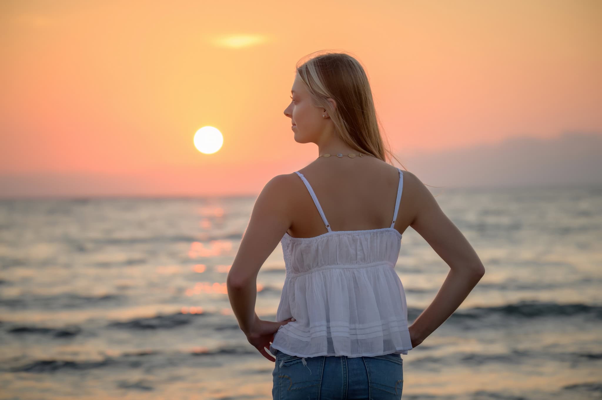 senior at sunset senior girl in front of the sunset going over the water at woodneck beach in falmouth, ma