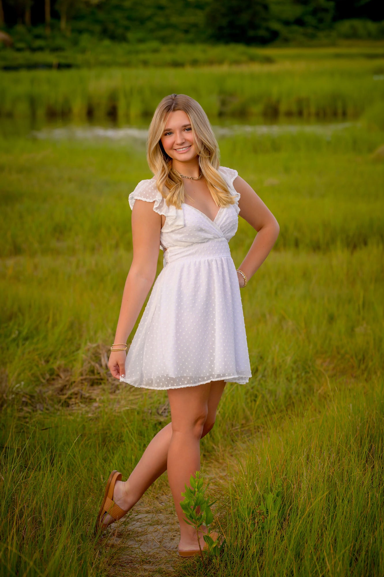 high school senior girl senior girl posing with the marsh at woodneck beach in falmouth