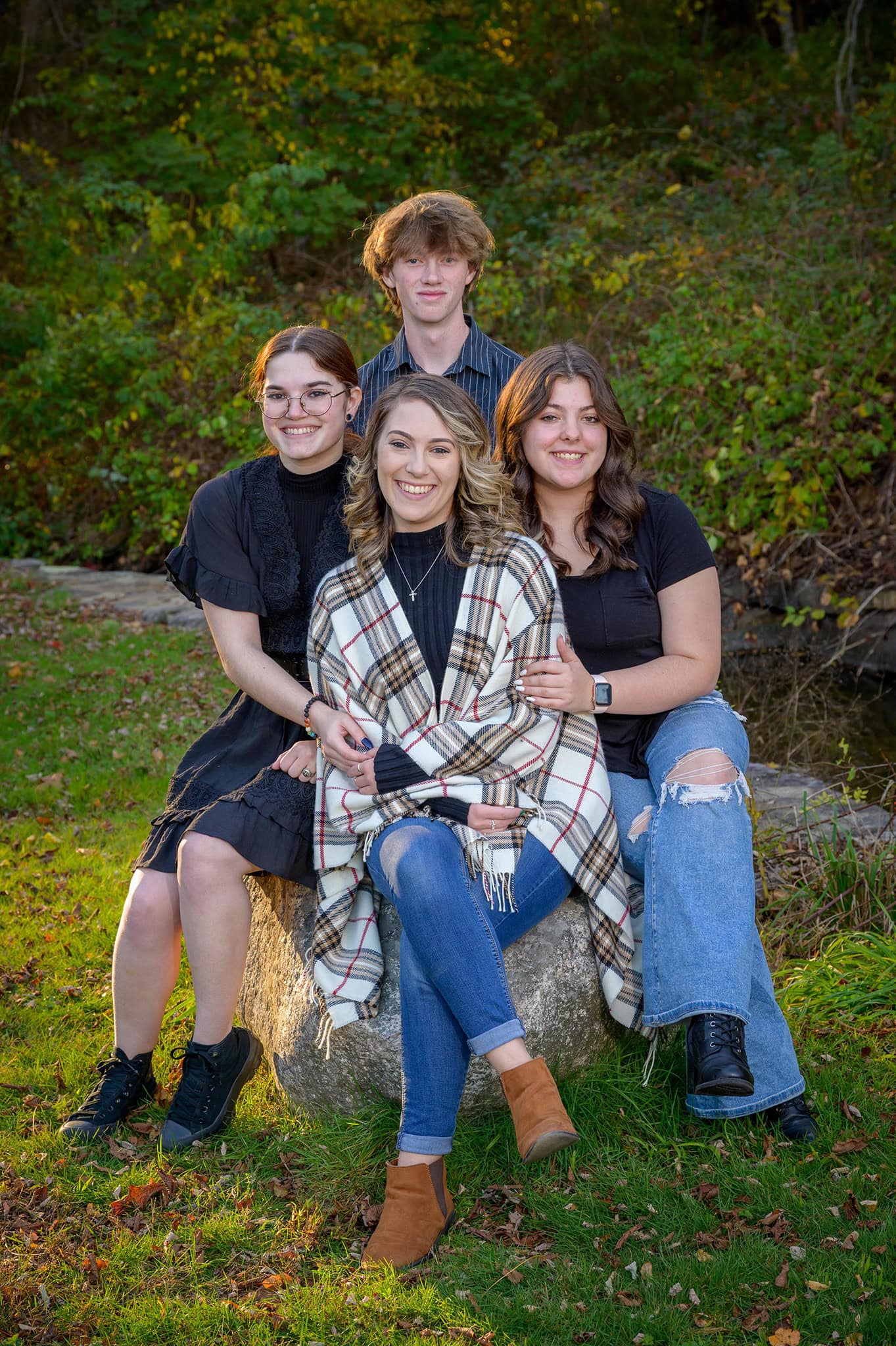 high school senior boy poses at a local park for his yearbook picture