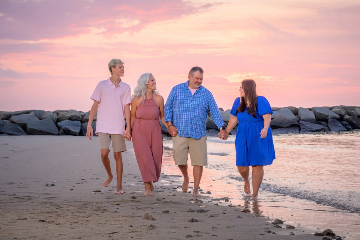 portrait of family walking along the water at cold storage beach, cape cod, at sunset