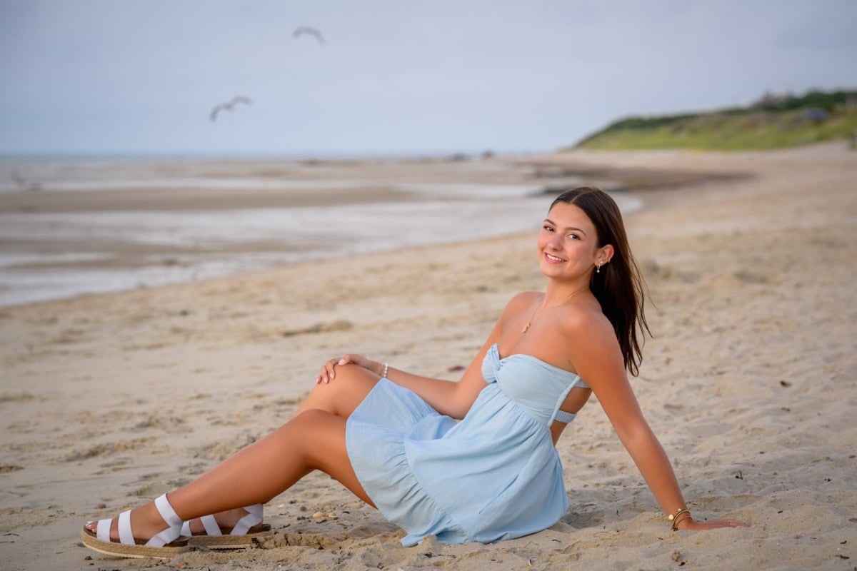 senior girl posing for senior pictures on cold storage beach, dennis, cape cod